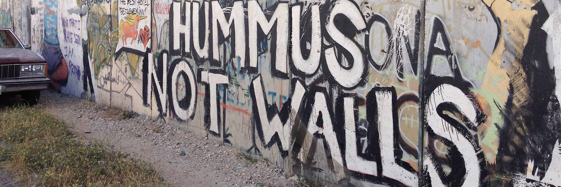 Graffiti on a wall that reads Make Hummus Not Walls